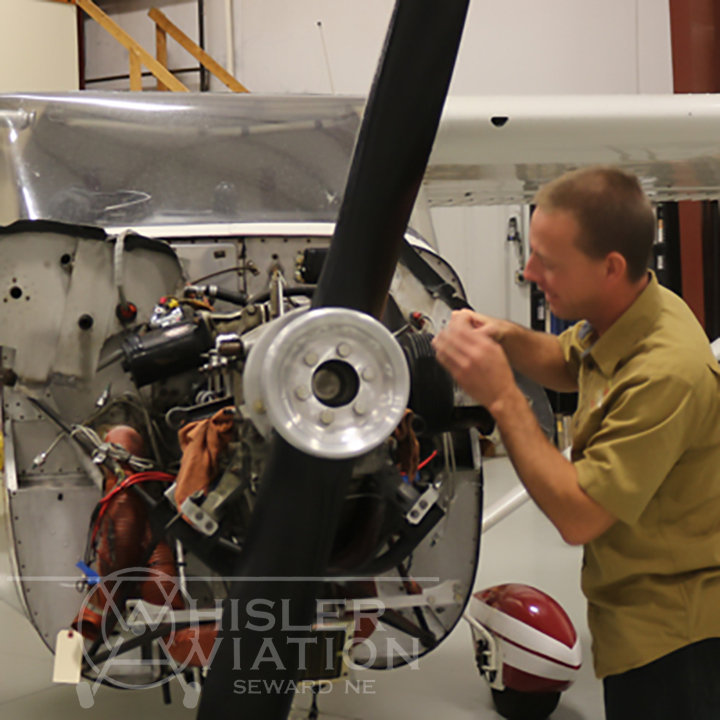 Jon working on the engine of a small aircraft at Whisler Aviation in Seward Nebraska