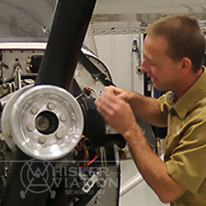 Jon working on the engine of a small aircraft at Whisler Aviation in Seward Nebraska