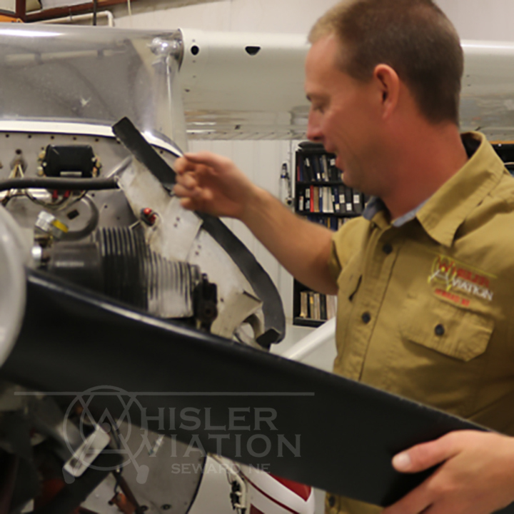 Jon working on the engine of a small aircraft at Whisler Aviation in Seward Nebraska